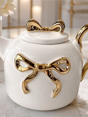 White Ceramic Teapot with Gold Bow Accents